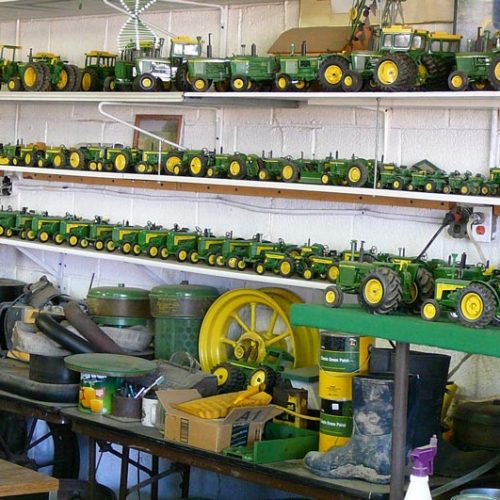 Collection of Restored Toy Tractors Stored In Shop