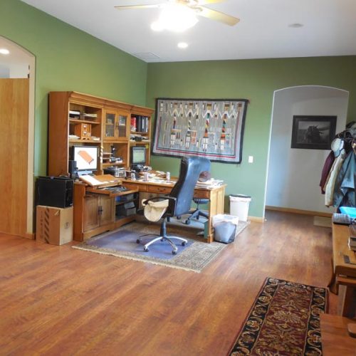 Home office with a large hardwood desk