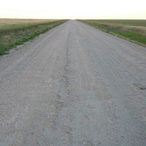 A long dirt road fading into the horizon.