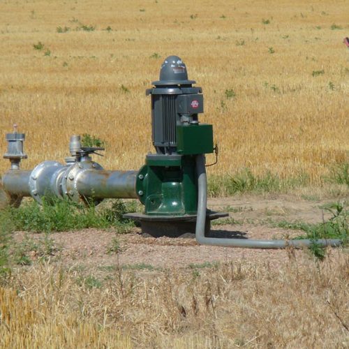 A shot of a water pump in place by a pole and electrical box